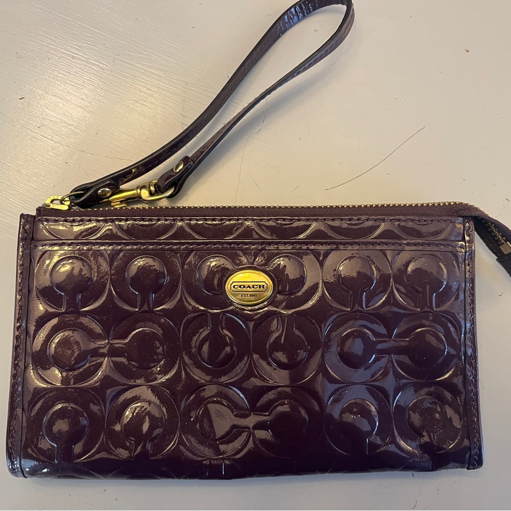 Coach Patent Purple Wristlet Wallet with Embossed Monogram.
